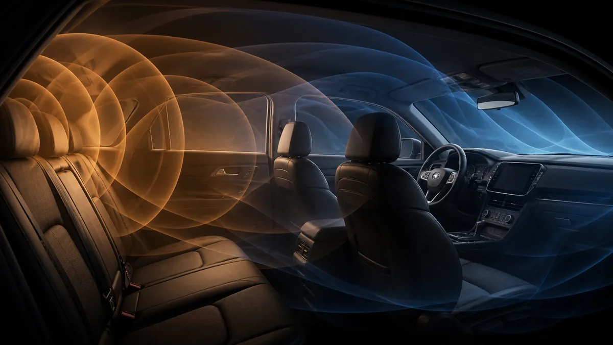 Abstract low-frequency pressure contours spreading through an unbranded vehicle cabin interior.
